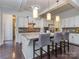 Bright, modern kitchen with white cabinetry, granite countertops, and an island with bar seating at 1041 Crofton Dr, Waxhaw, NC 28173
