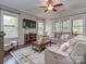 Comfortable living room area with natural light, ceiling fan, and neutral color scheme at 1041 Crofton Dr, Waxhaw, NC 28173