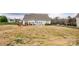 Spacious backyard with patio, fire pit, seating, and manicured lawn, perfect for outdoor activities at 118 Heathrow Ln, Statesville, NC 28677