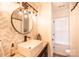 Modern bathroom with wood grain vanity, granite countertops, and a large round mirror at 118 Heathrow Ln, Statesville, NC 28677