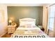 Charming bedroom featuring a decorative quilt, bedside table, and natural light from the windows at 118 Heathrow Ln, Statesville, NC 28677