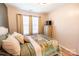 Cozy bedroom featuring a decorative quilt, bedside table, and natural light from the windows at 118 Heathrow Ln, Statesville, NC 28677