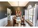 Elegant dining room featuring a dark accent wall, hardwood floors, and a large window at 118 Heathrow Ln, Statesville, NC 28677