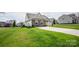 Well-kept single-Gathering home with a spacious yard, long driveway, and appealing stone and siding exterior at 118 Heathrow Ln, Statesville, NC 28677
