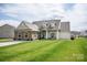 Charming single-Gathering home with stone accents, well-manicured lawn, and a welcoming covered front porch at 118 Heathrow Ln, Statesville, NC 28677