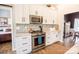Modern kitchen features stainless steel range and white cabinets with barndoor access at 118 Heathrow Ln, Statesville, NC 28677