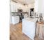 Bright kitchen features white cabinets, marble island, and stainless steel appliances at 118 Heathrow Ln, Statesville, NC 28677