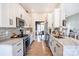Modern kitchen boasts white cabinets, marble countertops, and stainless steel appliances at 118 Heathrow Ln, Statesville, NC 28677