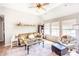 Cozy living room with a ceiling fan, comfortable seating, and natural light from the windows at 118 Heathrow Ln, Statesville, NC 28677