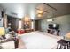 Spacious living room featuring a large rug, leather sofa, entertainment center, and natural light at 118 Heathrow Ln, Statesville, NC 28677