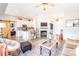 Open-concept living room with fireplace, wood floors, and view into modern kitchen at 118 Heathrow Ln, Statesville, NC 28677