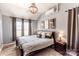 Comfortable main bedroom featuring neutral paint, natural lighting, and a decorative chandelier at 118 Heathrow Ln, Statesville, NC 28677