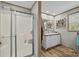 Bathroom featuring a glass-enclosed shower, vanity, and a window for natural light at 119 Old Hearth Rd, Clover, SC 29710