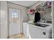 Functional laundry room with washer, dryer, and storage shelves near an exterior door at 119 Old Hearth Rd, Clover, SC 29710