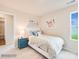 A charming bedroom is decorated with soft hues, complemented by a bright window and cheerful artwork at 12140 Devon Square Ct, Charlotte, NC 28262