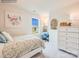 Bright bedroom featuring a window, whimsical decor, and a cozy desk area at 12140 Devon Square Ct, Charlotte, NC 28262
