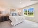Cozy bedroom with large window providing natural light and a scenic outdoor view at 12140 Devon Square Ct, Charlotte, NC 28262