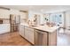 Bright kitchen boasts stainless appliances, spacious island, and hardwood floors at 12140 Devon Square Ct, Charlotte, NC 28262