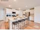 Modern kitchen with white cabinets, stainless steel appliances, a kitchen island with seating, and wood flooring at 12140 Devon Square Ct, Charlotte, NC 28262