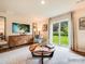 Cozy living room with sliding glass doors to the backyard, stylish furniture, and a modern rug at 12140 Devon Square Ct, Charlotte, NC 28262