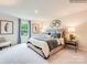 Spacious main bedroom with decorative lamps, soft carpet, and abundant natural light at 12140 Devon Square Ct, Charlotte, NC 28262