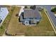 Aerial view showing home's large roof, manicured lawn, back porch and patio area at 1276 Stonecrest Blvd, Tega Cay, SC 29708