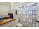 Clean bathroom with granite countertop vanity, toilet, and a patterned shower curtain at 1276 Stonecrest Blvd, Tega Cay, SC 29708