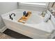 Close-up view of the bathtub with a caddy at 1276 Stonecrest Blvd, Tega Cay, SC 29708