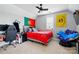 Bedroom with a ceiling fan, desk area, flags, and comfortable seating space at 1276 Stonecrest Blvd, Tega Cay, SC 29708
