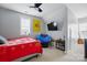 Bright bedroom featuring a ceiling fan, TV, and a large window with plenty of natural light at 1276 Stonecrest Blvd, Tega Cay, SC 29708