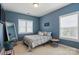 Blue bedroom with queen sized bed and two large windows at 1276 Stonecrest Blvd, Tega Cay, SC 29708