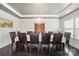 Formal dining room with elegant chandelier, hardwood flooring, and sophisticated decor at 1276 Stonecrest Blvd, Tega Cay, SC 29708