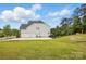 Home with a large, level backyard and three car garage, great for outdoor activities at 1276 Stonecrest Blvd, Tega Cay, SC 29708