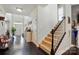 Inviting foyer with hardwood floors, staircase, and front door view at 1276 Stonecrest Blvd, Tega Cay, SC 29708