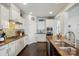 Modern kitchen featuring granite countertops, stainless steel appliances, and white cabinets at 1276 Stonecrest Blvd, Tega Cay, SC 29708