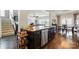Open-concept kitchen featuring a large island, stainless steel appliances, and hardwood flooring at 1276 Stonecrest Blvd, Tega Cay, SC 29708