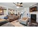 Open-concept living room flows into kitchen; features hardwood floors and fireplace at 1276 Stonecrest Blvd, Tega Cay, SC 29708