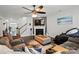 Bright living room boasting a fireplace, ceiling fan, and hardwood floors at 1276 Stonecrest Blvd, Tega Cay, SC 29708