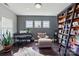 Cozy living room featuring a piano, comfortable seating, and a stylish bookshelf at 1276 Stonecrest Blvd, Tega Cay, SC 29708
