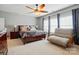 Spacious main bedroom with a ceiling fan and comfortable seating area near the windows at 1276 Stonecrest Blvd, Tega Cay, SC 29708