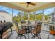 Cozy screened-in patio with a ceiling fan and dining area perfect for outdoor entertaining at 1276 Stonecrest Blvd, Tega Cay, SC 29708