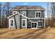 This home has a level backyard, dark siding, and white trim at 130 Big Oak Ln, Statesville, NC 28625