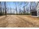 View of the large backyard with a newly built home in the distance at 130 Big Oak Ln, Statesville, NC 28625