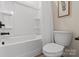 Full bathroom with a shower-tub combo, toilet, and white fixtures at 130 Big Oak Ln, Statesville, NC 28625