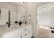Bathroom featuring double sinks, black hardware, and a large mirror at 130 Big Oak Ln, Statesville, NC 28625