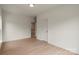 Bright bedroom with neutral walls, wood-look flooring, and a doorway leading to the hallway at 130 Big Oak Ln, Statesville, NC 28625