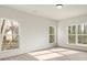 Bright bedroom with hardwood floors, three large windows, and recessed lighting at 130 Big Oak Ln, Statesville, NC 28625