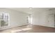 Well-lit bedroom with hardwood floors, bright windows, and a classic door at 130 Big Oak Ln, Statesville, NC 28625