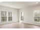 Large bright bedroom with hardwood floors, recessed lighting, and multiple windows with wooded views at 130 Big Oak Ln, Statesville, NC 28625