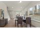 An open-concept dining area with hardwood floors, big windows, and view of the living area at 130 Big Oak Ln, Statesville, NC 28625
